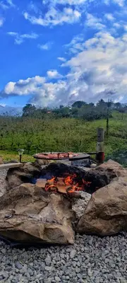 a fire pit with rocks on a field at Quinta Túru in Colonia