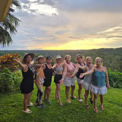 a group of women posing for a picture in the grass at Hacienda en Los Volcanes in Hacienda Guayabo