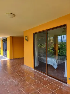 an empty house with glass doors and a patio at Hacienda en Los Volcanes in Hacienda Guayabo