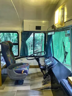a bus with a motorcycle sitting inside of it at Ficus Wonders Bus in Monteverde Costa Rica