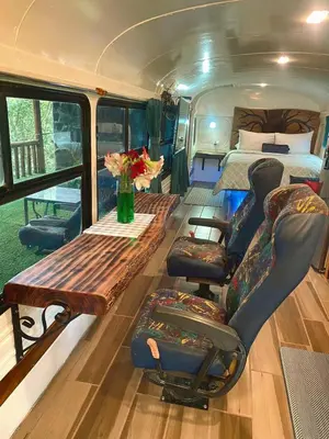 a van with a bed and a table and chairs at Ficus Wonders Bus in Monteverde Costa Rica