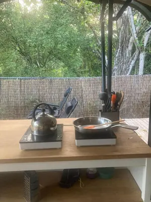 a kitchen counter with a bowl and a pan on it at Safari tent with private pool close to Manuel Antonio Glamping 1 in Matapalo