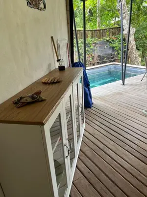 a kitchen with a counter and a deck with a pool at Safari tent with private pool close to Manuel Antonio Glamping 1 in Matapalo
