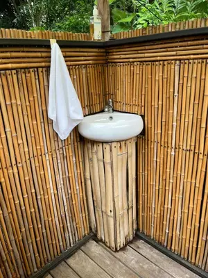 a sink on a wooden fence with a towel at Safari tent with private pool close to Manuel Antonio Glamping 1 in Matapalo