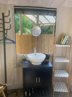 a bathroom with a sink and a mirror at Safari tent with private pool close to Manuel Antonio Glamping 1 in Matapalo
