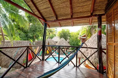 a porch with a hammock in a resort at Playa Grande Surf Camp in Playa Grande
