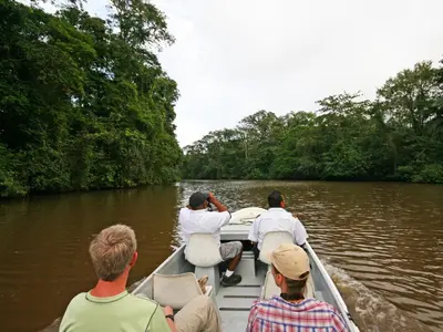 a group of people on a boat in the water at Manatus Hotel in Tortuguero