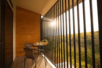 a balcony with a table and chairs and a large window at Victoria´s House in Grecia