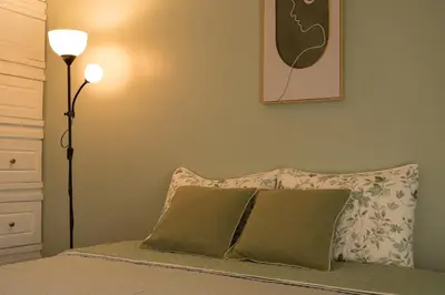 a bedroom with a bed with a pillow and a lamp at Victoria´s House in Grecia