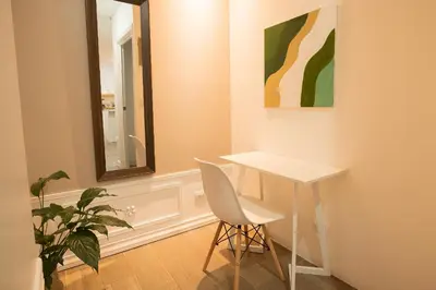 a table and a chair in a room with a mirror at Victoria´s House in Grecia