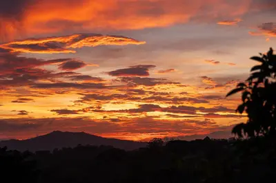a sunset with a mountain in the background at Victoria´s House in Grecia