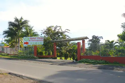 a gas station with a sign on the side of a road at Hotel Vista al Tortuguero in Cariari