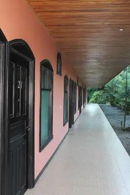 an empty hallway of a building with a black door at Hotel Vista al Tortuguero in Cariari