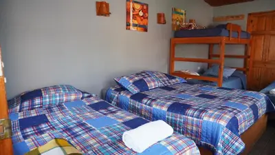 a bedroom with two beds and a bunk bed at Manakin Lodge, Monteverde in Monteverde Costa Rica