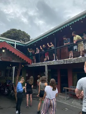 a group of people standing on the balcony of a building at Manakin Lodge, Monteverde in Monteverde Costa Rica