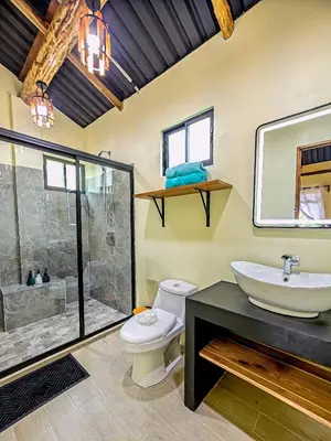 a bathroom with a toilet and a sink and a shower at Cabañas Caeli, El Toucan, Peaceful Rainforest Retreat with Stunning Views in Fortuna