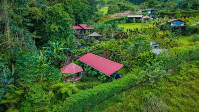 an aerial view of a village with houses on a hill at Cabañas Caeli, El Toucan, Peaceful Rainforest Retreat with Stunning Views in Fortuna