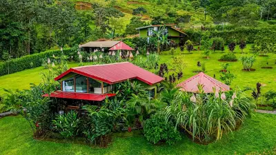an aerial view of a house with a red roof at Cabañas Caeli, La Perezosa, La Fortuna Rainforest Glass Cabin w Amazing Views in Fortuna