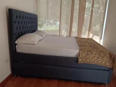 a bed in a room with a window at La Perla de Cobano in Puntarenas
