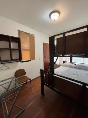 a bedroom with a bunk bed and a chair at La Perla de Cobano in Puntarenas