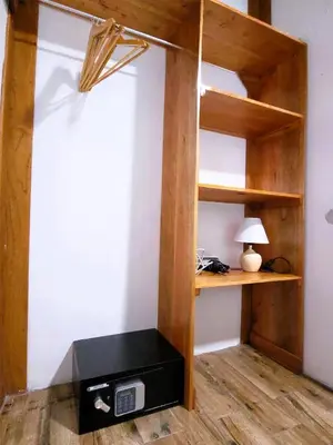 a room with a bunk bed with a desk at Arenal Sweet Cabins in Fortuna