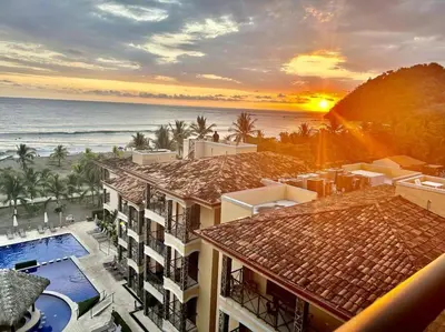a view of the ocean from a resort at Stylish 3-BR Vacation Condo with Scenic Rooftop in Jacó