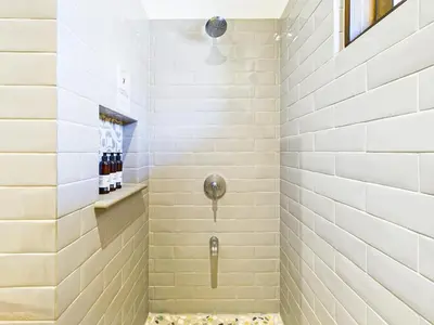a bathroom with a shower with white tiles at Paseo Divino At Las Catalinas in Playa Danta