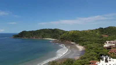 an aerial view of a beach with trees and houses at Paseo Divino At Las Catalinas in Playa Danta