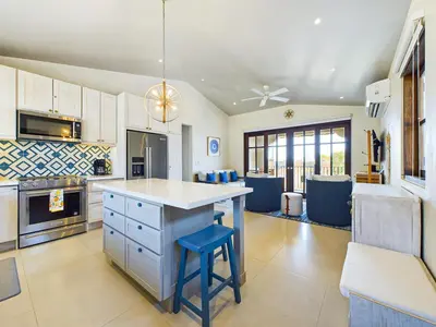 a kitchen with a island with a blue stool at Paseo Divino At Las Catalinas in Playa Danta