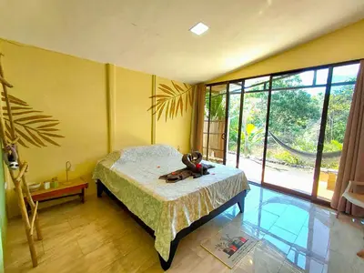 a bedroom with a bed with a teddy bear on it at Kocorica in Parrita