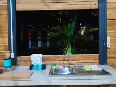 a kitchen sink in front of a window at Kocorica in Parrita