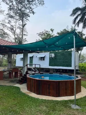 a swimming pool with a tent and a house at Trailer House in Vara Blanca