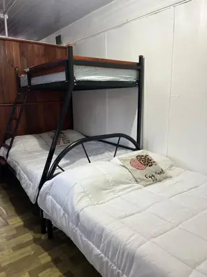 two bunk beds in a room with a bed at Trailer House in Vara Blanca