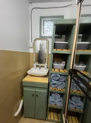 a bathroom with a sink and a mirror and towels at Trailer House in Vara Blanca