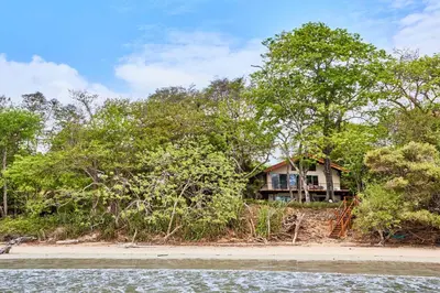 a house on the shore of a beach at Casa Corona Del Mar Tamarindo in Tamarindo