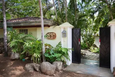 a house with a gate in front of it at Casa Corona Del Mar Tamarindo in Tamarindo