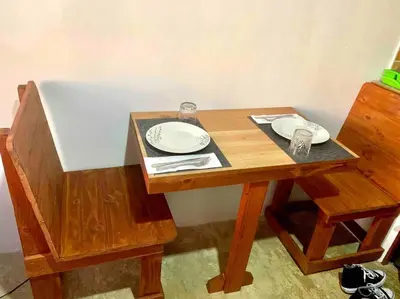 a wooden table with two plates on top of it at Cotinga Nest - King Bed, Ocean View in San Pedrillo