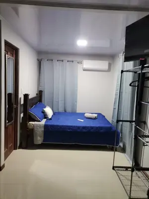 a bedroom with a blue bed in a room at Bee in Veintisiete de Abril