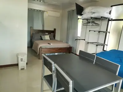 a bedroom with a bed and bunk beds in it at Bee in Veintisiete de Abril