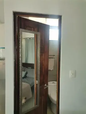 a bathroom with a mirror and a toilet at Bee in Veintisiete de Abril