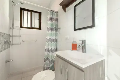 a bathroom with a sink and a toilet at Pura Armonia Condo with Outdoor Patio in Coco
