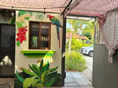 a bird on the side of a house with a painting at Pura Armonia Condo with Outdoor Patio in Coco