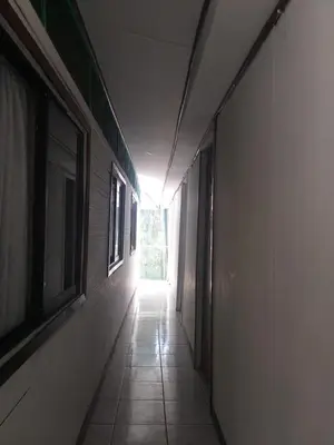 an empty hallway with a light at the end of a building at Downtown Montezuma Hostel in Montezuma