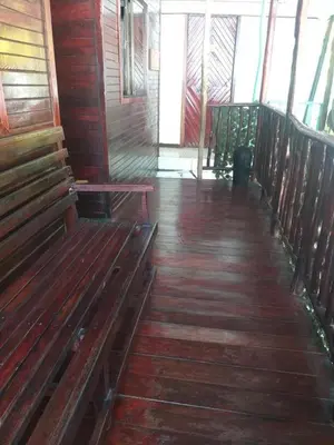 an empty room with wooden benches in a cabin at Downtown Montezuma Hostel in Montezuma