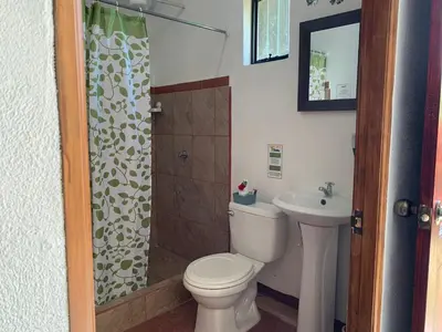 a bathroom with a toilet and a shower and a sink at Globi Lodge #6 in Monteverde Costa Rica
