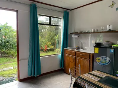 a kitchen with a window and a sink and a table at Globi Lodge #6 in Monteverde Costa Rica