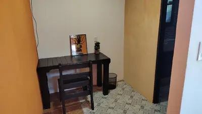 a small table with a chair in a room at Persea Inn & Restaurante Toro Careto in El Copey