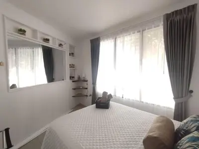 a bedroom with a bed with a teddy bear sitting on it at Hotel Boutique CasAguacate Apt Morfo close to Airport in Potrerillos