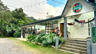 a woman is standing outside of a building at Nomada Monteverde in Monteverde Costa Rica