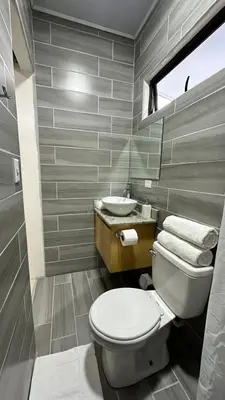 a bathroom with a toilet and a sink at Nomada Monteverde in Monteverde Costa Rica